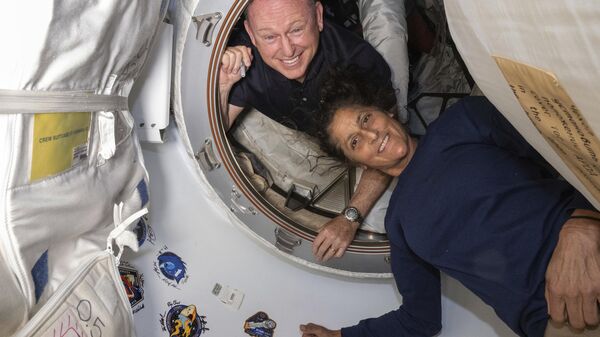 In this photo provided by NASA, Boeing Crew Flight Test astronauts Butch Wilmore, left, and Suni Williams pose for a portrait inside the vestibule between the forward port on the International Space Station's Harmony module and Boeing's Starliner spacecraft on June 13, 2024. - Sputnik Africa