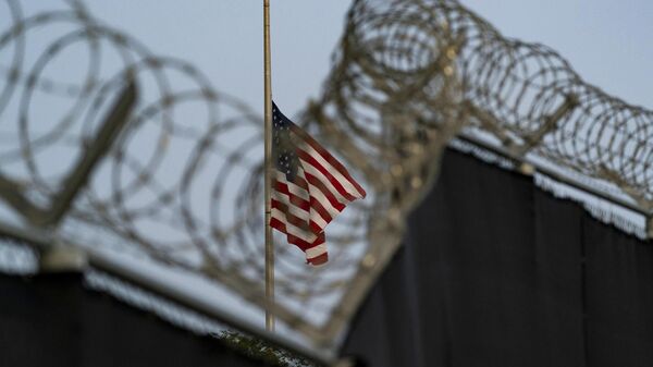 In this photo reviewed by US military officials, a flag flies at half-staff in honor of the US service members and other victims killed in the terrorist attack in Kabul, Afghanistan, as seen from Camp Justice in Guantanamo Bay Naval Base, Cuba, Aug. 29, 2021. - Sputnik Africa