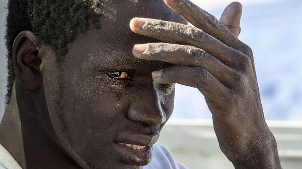 A file photo dates March 13, 2015 shows An illegal migrant reacts at the coast of Souq al Jum'aa region in Tripoli, Libya after they got captured. - Sputnik Africa