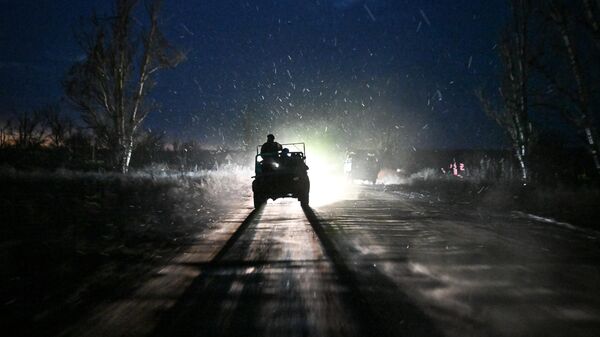 Russian servicemen ride a vehicle along a road  - Sputnik Africa