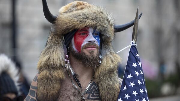 WASHINGTON, DC - JANUARY 06: Jacob Chansley, a.k.a. Jake Angeli and the QAnon Shaman, speaks to passersby during the Stop the Steal rally on January 06, 2021 in Washington, DC. - Sputnik Africa