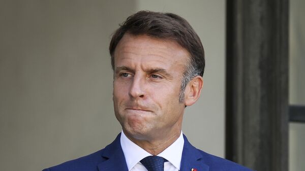 French President Emmanuel Macron gestures at the Elysee Palace as French left-wing coalition accuses Emmanuel Macron of denying democracy after he has rejected the New Popular Front's candidate to form a new government following last month's inconclusive election, Tuesday, Aug. 27, 2024 in Paris. - Sputnik Africa