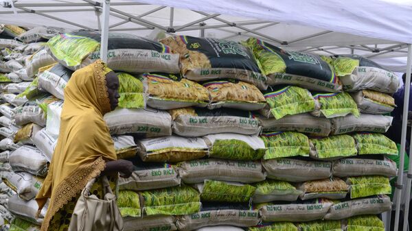 A woman walks past a stand loaded with Eko Rice as the Lagos State Ministry of Agriculture and Food Systems concludes activities for the 2024 World Food Day, tagged Eko World Food Day, with a fair and parade of produce by farmers from different local government areas of the state at Police College in Ikeja, Lagos, Nigeria, on October 16, 2024. - Sputnik Africa