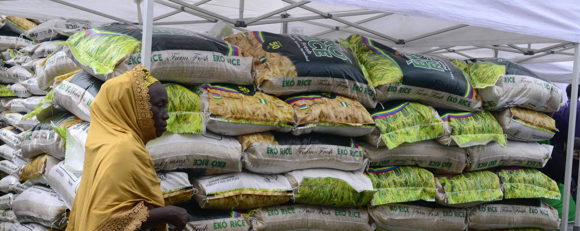 A woman walks past a stand loaded with Eko Rice as the Lagos State Ministry of Agriculture and Food Systems concludes activities for the 2024 World Food Day, tagged Eko World Food Day, with a fair and parade of produce by farmers from different local government areas of the state at Police College in Ikeja, Lagos, Nigeria, on October 16, 2024. - Sputnik Africa, 1920, 12.01.2025