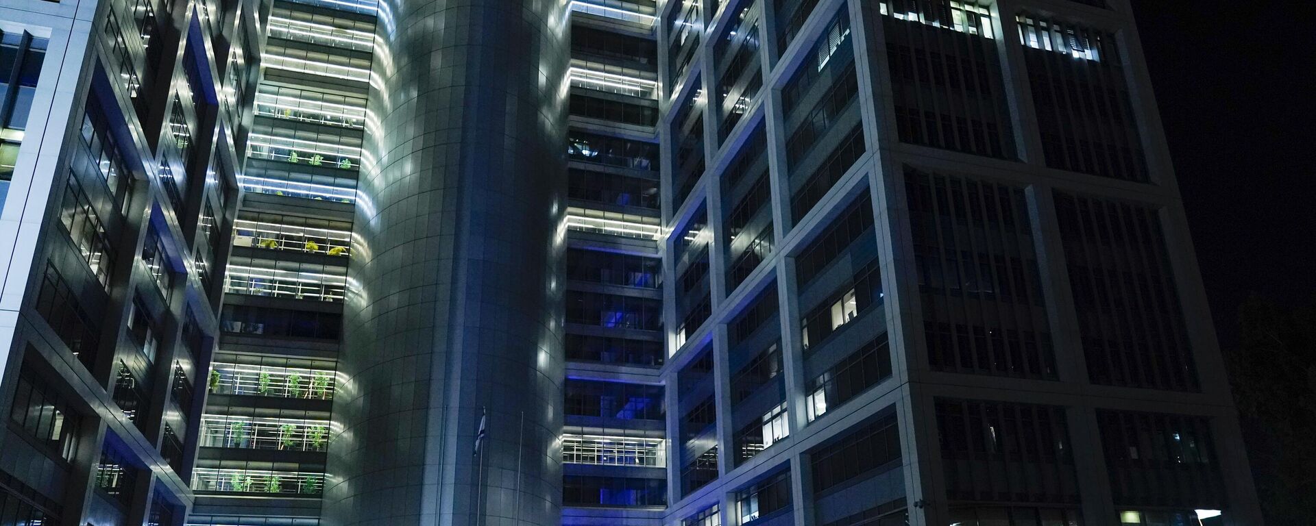 People walk outside a building on The Kirya, which houses Israel's Ministry of Defense, Monday, Oct. 16, 2023, in Tel Aviv.  - Sputnik Africa, 1920, 14.01.2025