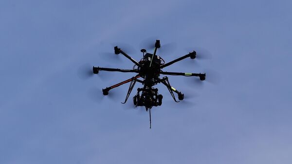 A drone camera flies in the sky during the Nordic Combined HS100 Normal Hill Ski Jumping team event during the FIS Nordic World Ski Championships at the Lugnet venue on February 22, 2015 in Falun, Sweden.  - Sputnik Africa