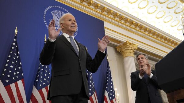 President Joe Biden, left, standing next to Secretary of State Antony Blinken, right, tells the audience to sit as he gets a standing ovation before making a speech about foreign policy at the State Department in Washington, Monday, Jan. 13, 2025.  - Sputnik Africa