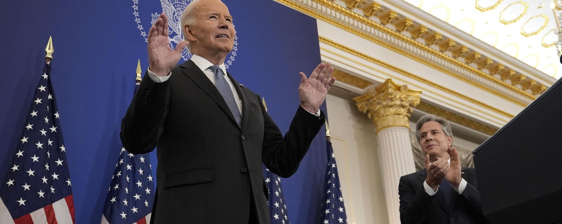 President Joe Biden, left, standing next to Secretary of State Antony Blinken, right, tells the audience to sit as he gets a standing ovation before making a speech about foreign policy at the State Department in Washington, Monday, Jan. 13, 2025.  - Sputnik Africa, 1920, 15.01.2025