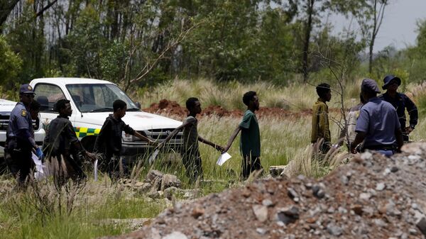 Illegal miners escorted by police officers after being rescued from an abandoned gold mine in Stilfonteinin, South Africa, Tuesday, Jan. 14, 2025.  - Sputnik Africa