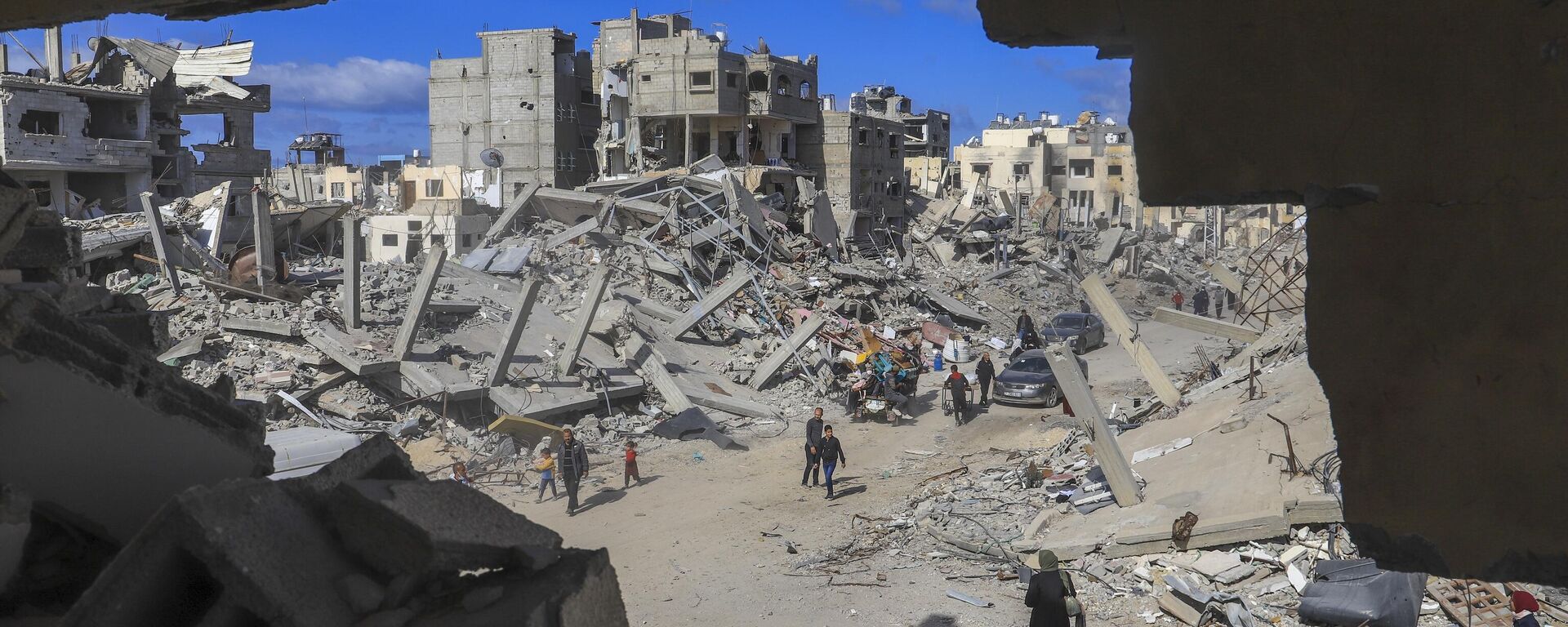 Palestinians walk through the rubble caused by the Israeli air and ground offensive in Rafah, southern Gaza Strip, Monday, Jan. 20, 2025. - Sputnik Africa, 1920, 21.01.2025