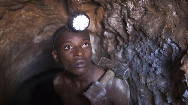 Nsinku Zihindula (25), who works 24-hour shifts, hammers at solid rock to find cassiterite ore at Szibira. Nsinku was blinded in his left eye by flying rock, but must continue to work in the dangerous tunnels to earn money to feed his wife and child.  - Sputnik Africa