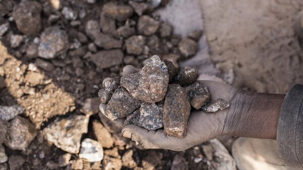 A miner collects small chunks of cobalt inside the CDM (Congo DongFang Mining) Kasulo mine. - Sputnik Africa