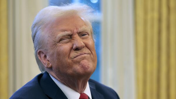 U.S. President Donald Trump reacts to a reporter's question from the Resolute Desk after signing an executive order to appoint the deputy administrator of the Federal Aviation Administration in the Oval Office at the White House on January 30, 2025 in Washington, DC.  - Sputnik Africa