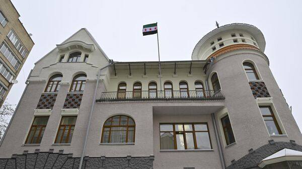 Syrian opposition's 'revolution flag' flies at the Syrian embassy after the overthrow of the 61-year Baath Party rule, in Moscow, Russia on December 09, 2024. - Sputnik Africa