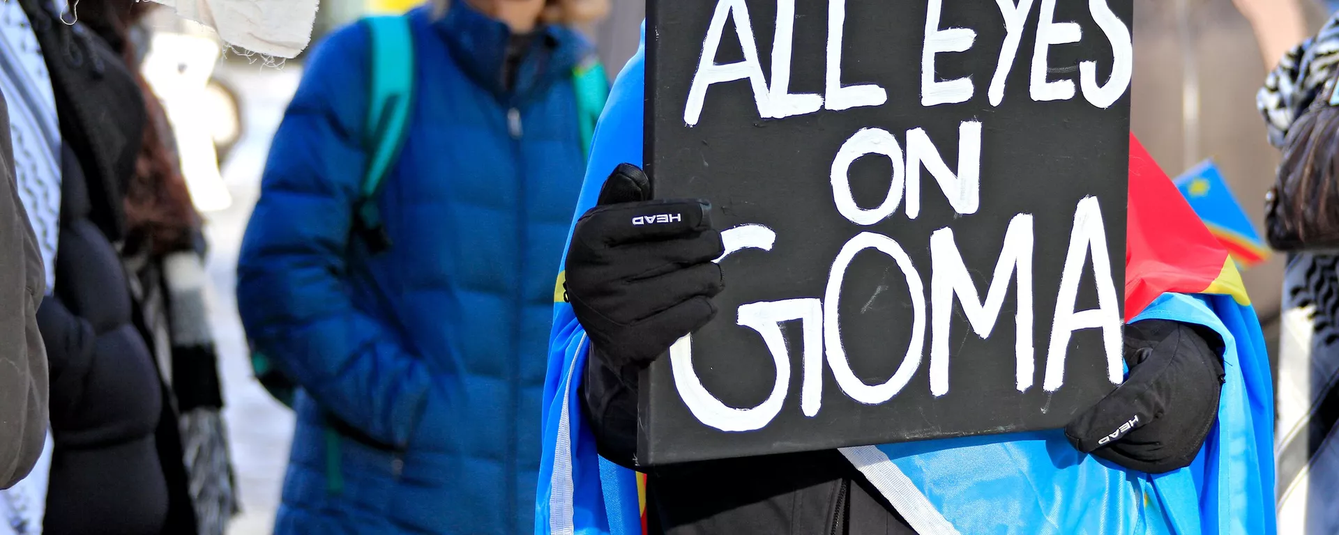 A protestor holds a sign at a rally at Yonge-Dundas Square to bring attention to the humanitarian crisis and regional instability in the Democratic Republic of Congo, where multiple armed groups, including the M23 rebels, are active, in Toronto, Canada, on February 1, 2025. - Sputnik Africa, 1920, 06.02.2025
