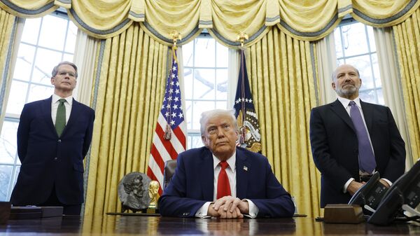 US Secretary of Treasury Scott Bessent (L) and Howard Lutnick, US President Donald Trump's nominee for Commerce Secretary, (R) stand behind US President Donald Trump as he speaks to reporters in the Oval Office of the White House on February 03, 2025 in Washington, DC. - Sputnik Africa