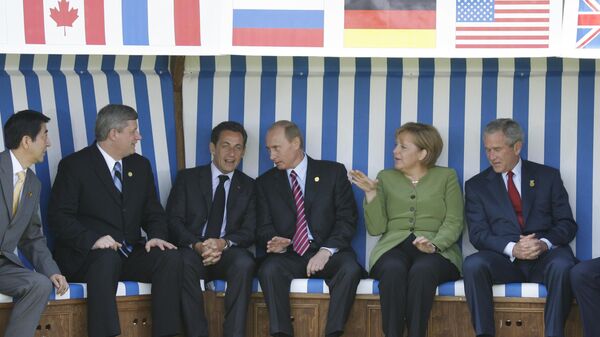 Heads of States are posing for a family photo in a huge deckchair In Heiligendamm, Germany On June 07, 2007-Japan Prime Minister Shinzo Abe, Canadian Prime Minister Stephen Harper, French President Nicolas Sarkozy, Russian President Vladimir Putin, German Chancellor Angela Merkel, United States President George W. Bush. - Sputnik Africa