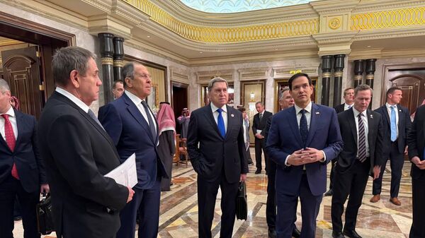 Russian Foreign Minister Sergey Lavrov (C) and Russian President Vladimir Putin's Foreign Policy Advisor Yuri Ushakov (2nd R) chat with Saudi Arabian officials, following meeting between Russia and the United States in Ukraine, in Riyadh, Saudi Arabia, on February 18, 2025. The talks aimed at improving relations between the two nations and addressing the conflict in Ukraine.  - Sputnik Africa