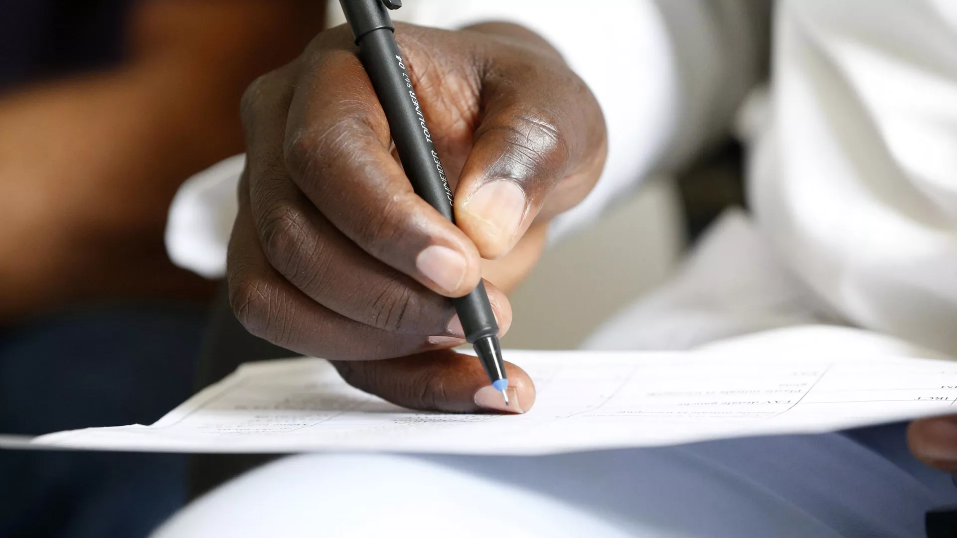 Man writing with a pencil