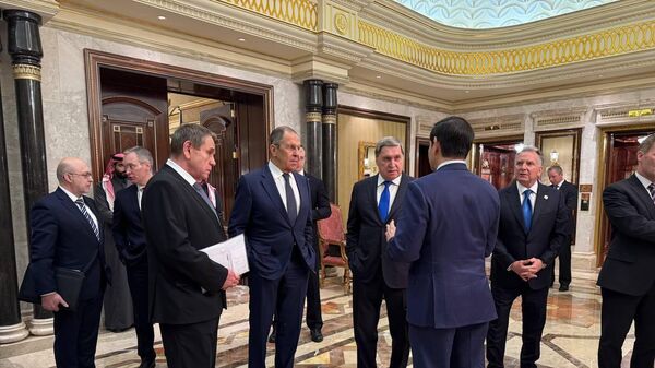 Russian Foreign Minister Sergey Lavrov (C) and Russian President Vladimir Putin's Foreign Policy Advisor Yuri Ushakov (2nd R) chat with Saudi Arabian officials, following meeting between Russia and the United States in Ukraine, in Riyadh, Saudi Arabia, on February 18, 2025. The talks aimed at improving relations between the two nations and addressing the conflict in Ukraine.  - Sputnik Africa