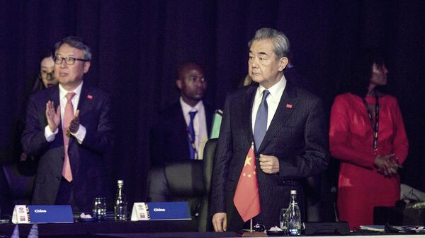 Wang Yi, the foreign minister of China, looks at South African president Cyril Ramaphosa, as he arrives at the first G20 Foreign Minister's Meeting, hosted by South Africa on February 20, 2025 at Nasrec Convention Center in Johannesburg, South Africa.  - Sputnik Africa