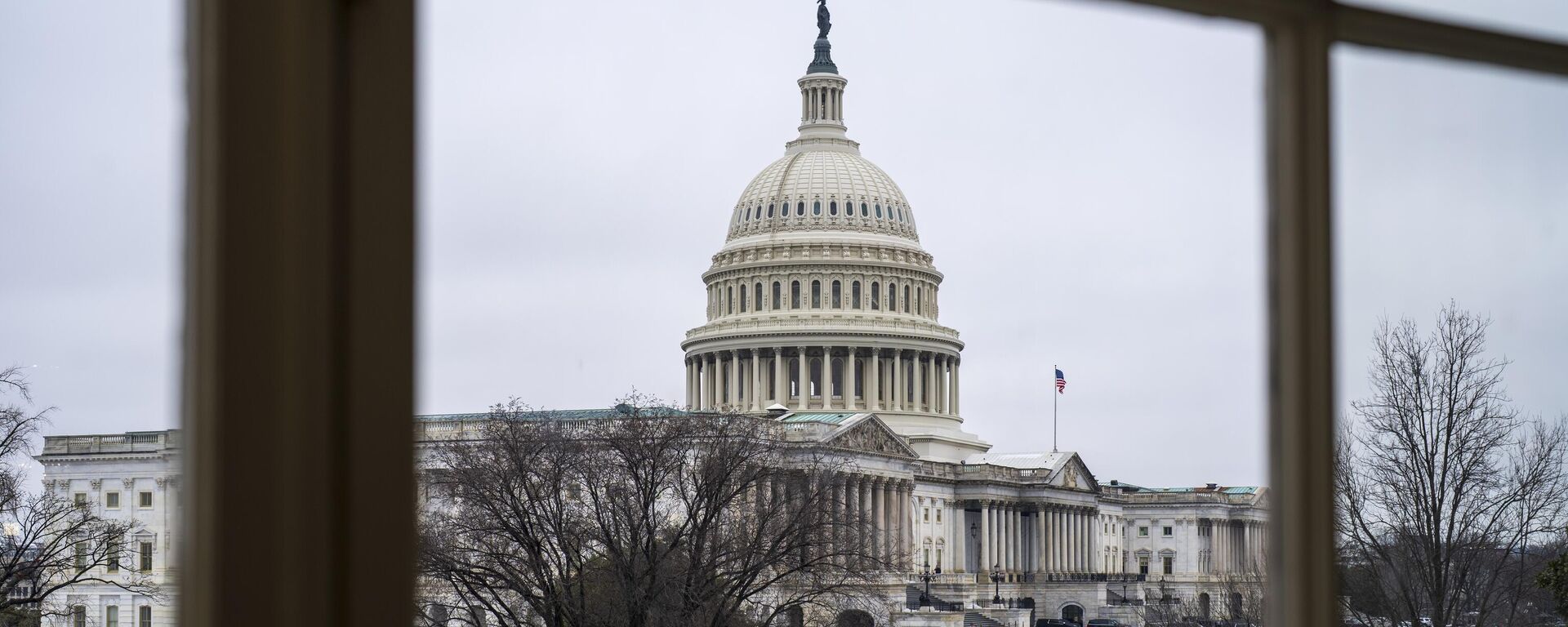 The Capitol is seen framed through a window in the Cannon House Office Building on Capitol Hill in Washington, Thursday, Feb. 13, 2025. - Sputnik Africa, 1920, 21.02.2025