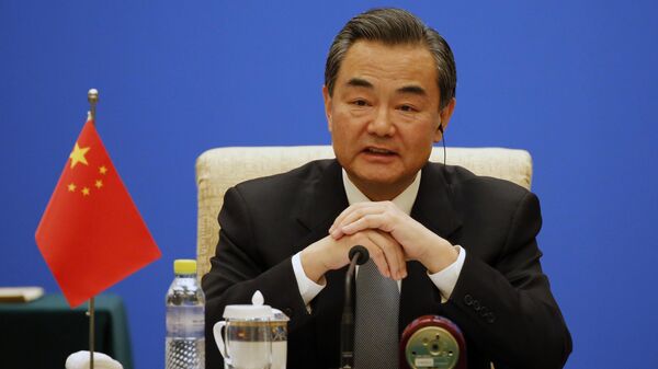 Chinese Foreign Minister Wang Yi speaks duriong the meeting of the Foreign Ministers of China, Russia and India at Diaoyutai State guesthouse in Beijing Monday, Feb. 2, 2015 - Sputnik Africa