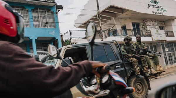 M23 rebels in a jeep drive past a motorcycle taxi rider on February 20, 2025 in Bukavu, Democratic Republic of Congo.  - Sputnik Africa