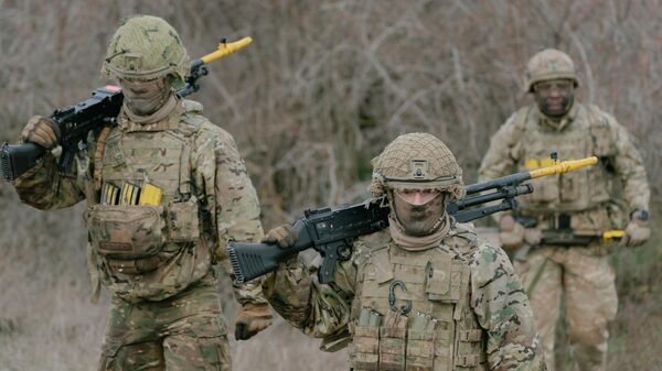 British soldiers walk back to their vehicles at the end of an exercise on February 17, 2025, in Smardan, Romania.  - Sputnik Africa