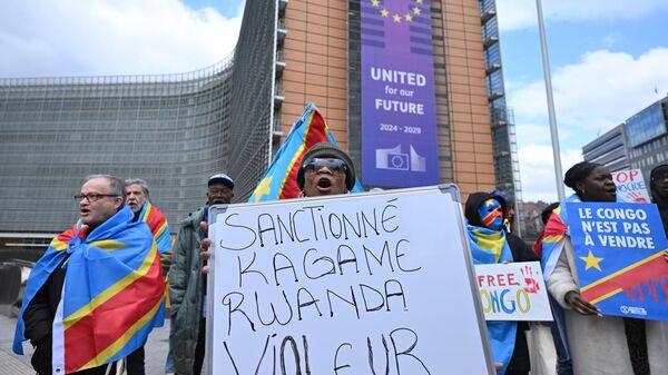 A group of demonstrators blaming Rwanda for the conflict in eastern Democratic Republic of Congo (DRC) gather with placards in Schuman Roundabout square in front of European Commission headquarters to call on the EU to impose sanctions against Rwanda in Brussels, Belgium on March 17, 2025.  - Sputnik Africa