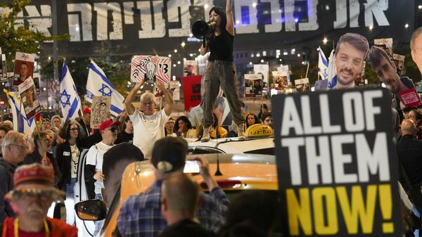 Protesters demand the release of hostages held in the Gaza Strip, in Tel Aviv, Israel, Tuesday, March 18, 2025. - Sputnik Africa