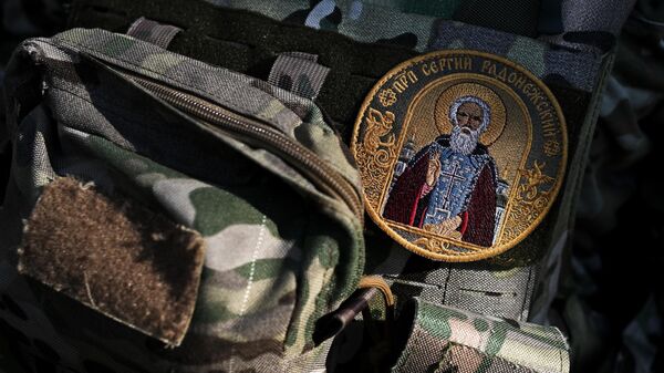 A patch on the uniform of a clergyman during an Easter service for servicemen of the 56th Airborne Assault Brigade of the Airborne Forces of the North Group of Forces in the Kursk Region. - Sputnik Africa