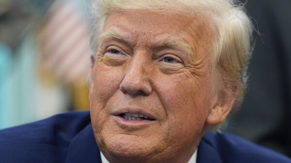 President Donald Trump speaks with reporters as he signs an executive order in the Oval Office of the White House, Friday, May 9, 2025, in Washington. - Sputnik Africa
