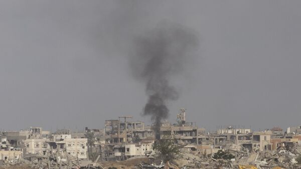 Smoke rises over the southern Gaza Strip on May 19, 2025 as seen from Southern Israel. The Israeli military has said its expanding ground operations in Gaza as part of what they're calling 'Operation Gideon's Chariots,' aimed at securing the release of hostages still held in Gaza, as well as the defeat of Hamas. - Sputnik Africa
