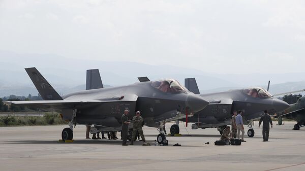 US military personnel work near F-35 fighter jets of the Vermont Air National Guard, parked in the military base at Skopje Airport, North Macedonia, on June 17, 2022.  - Sputnik Africa
