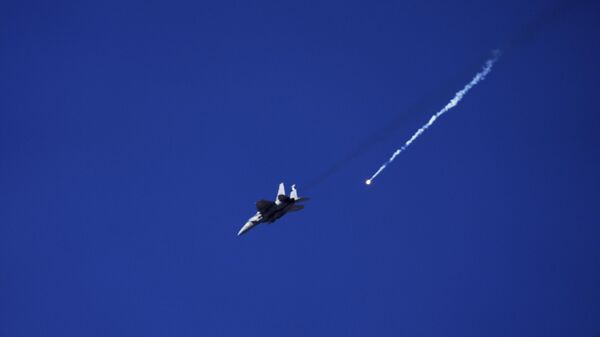 An Israeli Air Force fighter jet releases flares over the Gaza Strip, is seen from southern Israel, Thursday, May 8, 2025.  - Sputnik Africa