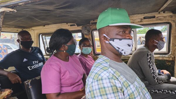 Passengers sit in a bus after the government eased the restriction on vehicular movement due to the novel coronavirus (Covid-19) pandemic after a 6-weeks lockdown paralysed businesses in Lagos, Nigeria on May 05, 2020.  - Sputnik Africa