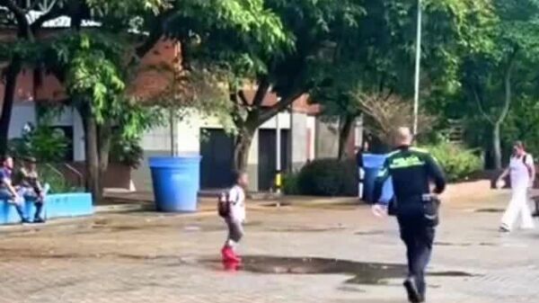 Quand tu n'as pas oublié ton enfance: un policier colombien partage avec un enfant la joie de sauter dans une flaque - Sputnik Afrique