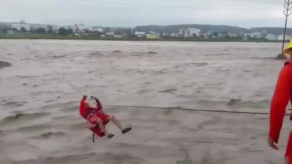 Sauvetage spectaculaire en Inde: un homme emporté par une rivière lors de fortes pluies - Sputnik Afrique