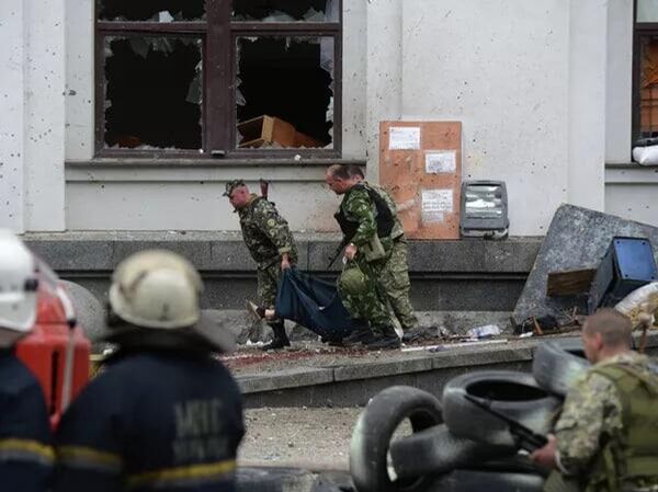 People's militiamen carry a victim of the air strike of the Ukrainian air force on the building of the regional administration in Luпansk. People's militiamen carry a victim of the air strike of the Ukrainian air force on the building of the regional administration in Luпansk. - Sputnik Africa