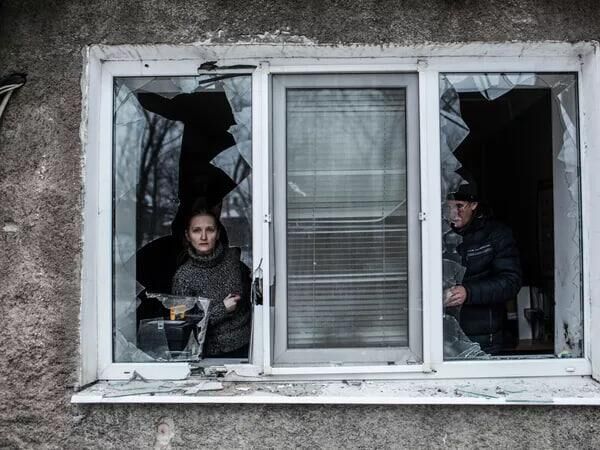 A woman looks through a broken window of her apartment after it was hit by Ukrainian artillery in the Voroshilovsky district of central Donetsk. A woman looks through a broken window of her apartment after it was hit by Ukrainian artillery in the Voroshilovsky district of central Donetsk. - Sputnik Africa