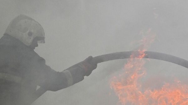 A rescuer fights a fire at a motor oil production facility in the Moscow region. - Sputnik Africa