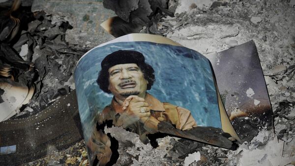 Picture of Libya's ousted leader Moammar Gadhafi is seen in the ashes in downtown Sirte, Libya, Wednesday, Oct. 12, 2011.  - Sputnik Africa