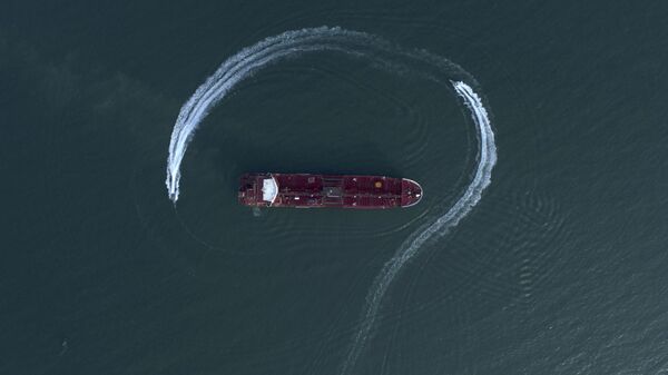 An aerial view shows a speedboat of Iran's Revolutionary Guard moving around the British-flagged oil tanker Stena Impero which was seized in the Strait of Hormuz in 2019 by the Guard, in the Iranian port of Bandar Abbas - Sputnik Africa