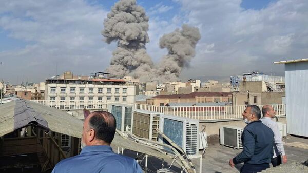 People watch as smoke rises on the skyline after an explosion in Tehran, Iran, Saturday, Feb. 28, 2026.(AP Photo) - Sputnik Africa