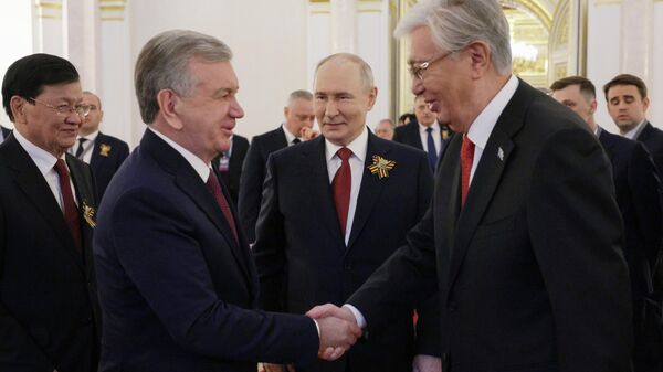Russian President Vladimir Putin, Lao President Thongloun Sisoulith (background, left), Uzbek President Shavkat Mirziyoyev (foreground, left), and Kazakh President Kassym-Jomart Tokayev after a reception in the Kremlin for heads of foreign delegations on Victory Day. May 9, 2026.  - Sputnik Africa