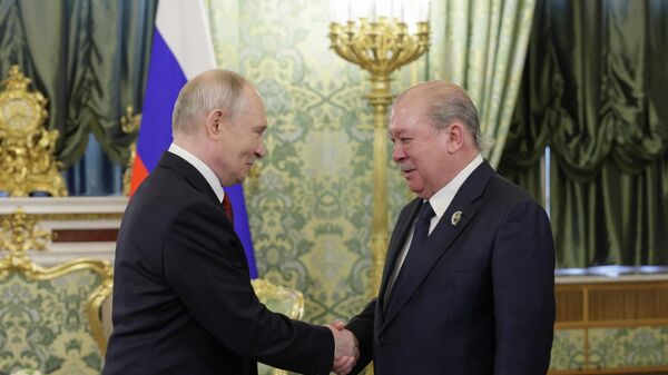 May 9, 2026. Russian President Vladimir Putin and Malaysia's Supreme Ruler Sultan Ibrahim (right) during a meeting in Moscow. - Sputnik Africa