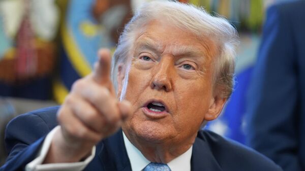 President Donald Trump answers questions from reporters during a meeting with the White House task force on the 2026 FIFA World Cup in the Oval Office of the White House, Monday, Nov. 17, 2025, in Washington - Sputnik Africa
