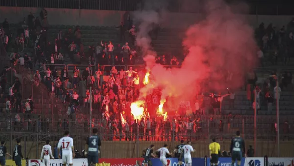 Firefighters try to extinguish a fire on a truck as a riot broke out outside of a major soccer match between Egyptian Premier League clubs Zamalek and ENPPI at Air Defense Stadium - Sputnik Afrique