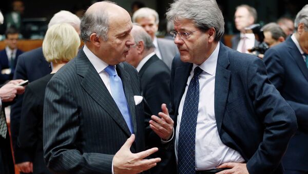 French Foreign Minister Laurent Fabius talks to his Italian counterpart Paolo Gentiloni (R) during an European Union foreign ministers meeting in Brussels February 9, 2015. - Sputnik Afrique